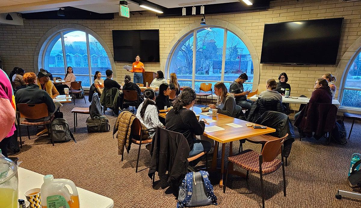 CERI dialogue event with students sitting at tables around a room